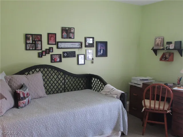 a bedroom with a bed and a chair