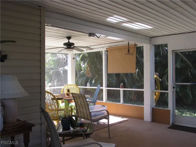 a view of a porch with furniture and next to a yard