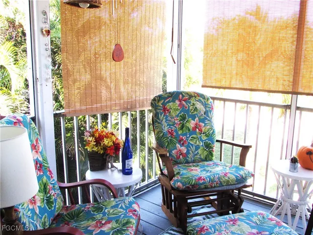 a living room filled with furniture and a potted plant
