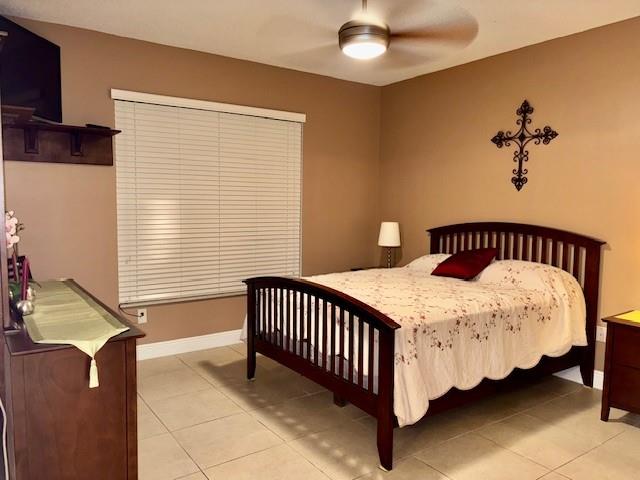 5880 West Sample Road, Unit 105 Coral Springs, FL 33067 - Photo 12 of 23 a bedroom with a bed and window