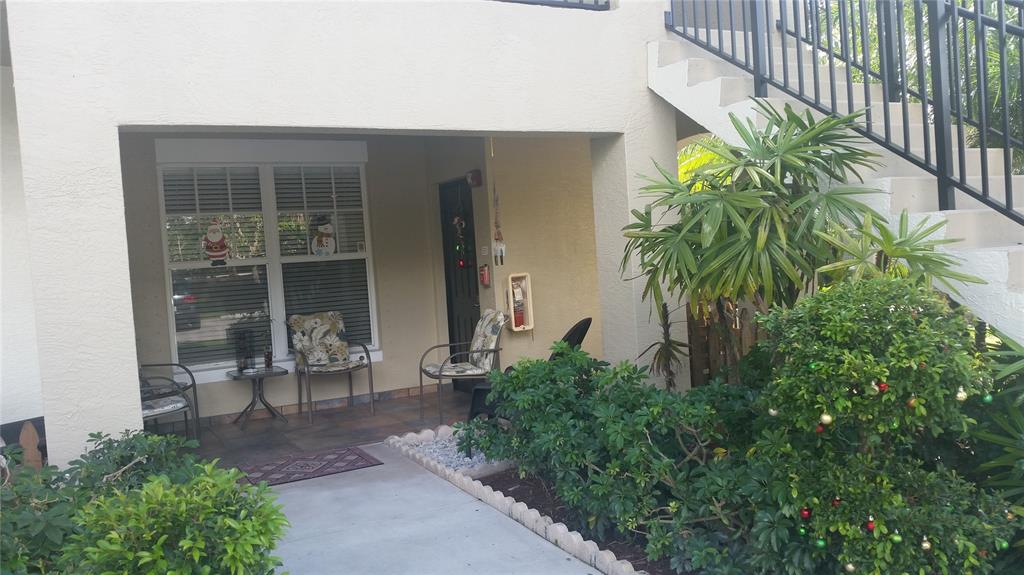 5880 West Sample Road, Unit 105 Coral Springs, FL 33067 - Photo 2 of 23 a couple of potted plants in front of door