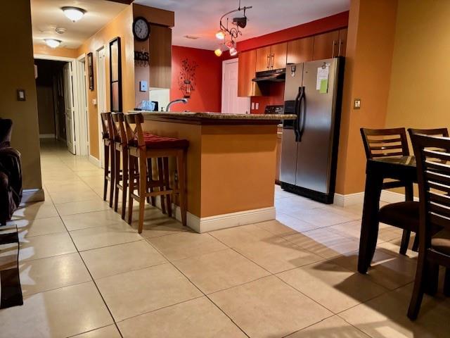 5880 West Sample Road, Unit 105 Coral Springs, FL 33067 - Photo 3 of 23 a kitchen with stainless steel appliances granite countertop a sink and a refrigerator