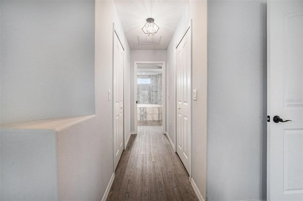 7403 Northeast 22nd Ct Road Ocala, FL 34479 - Photo 17 of 37 a view of a hallway with wooden floor