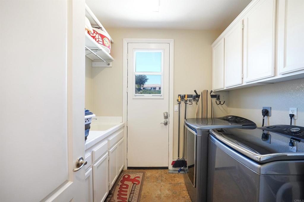 22963 Stokes Road Ramona, CA 92065 - Photo 45 of 57 a kitchen with a sink and refrigerator