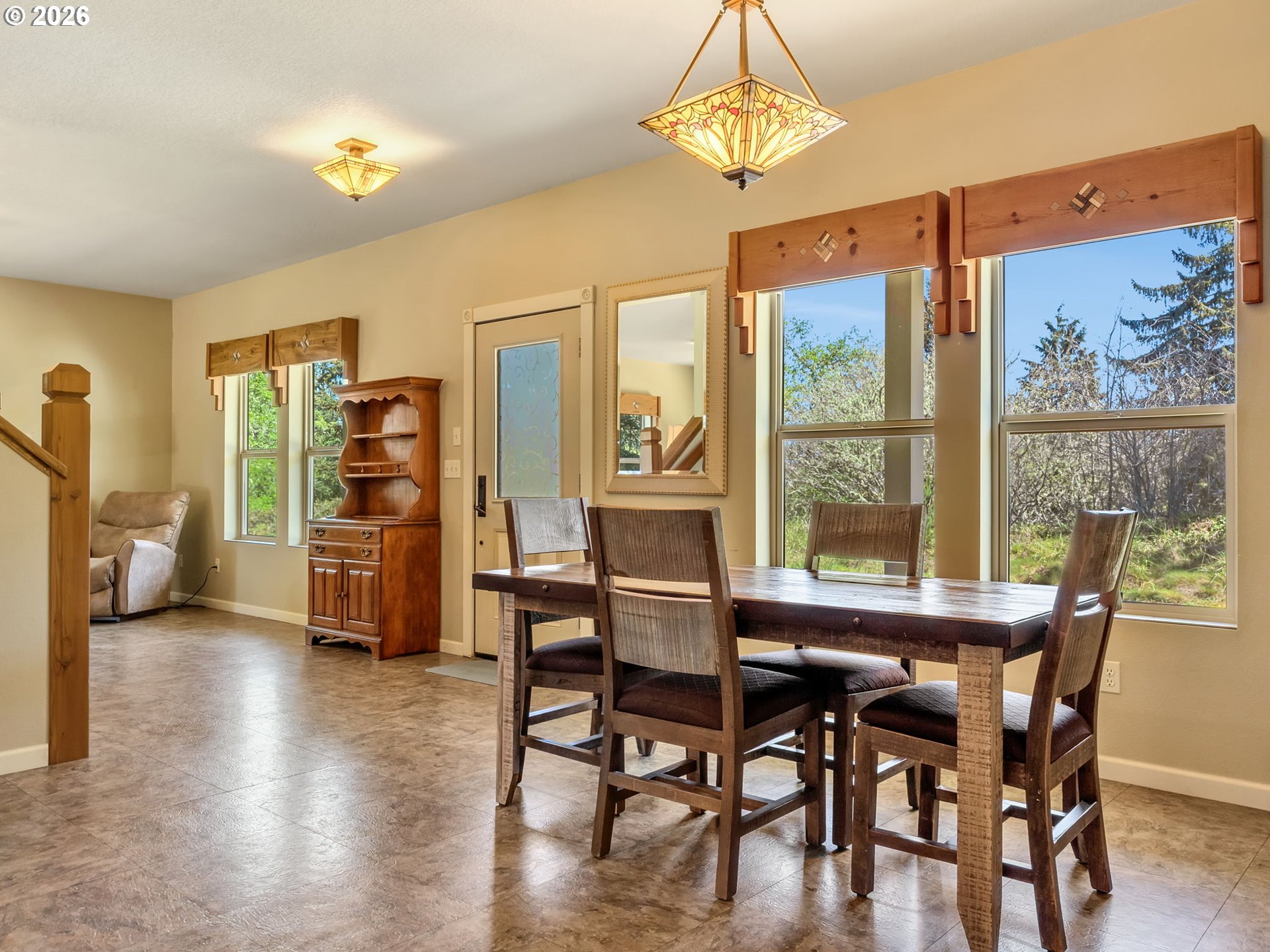 1077 Southwest Ridge Road Warrenton, OR 97146 - Photo 25 of 46 a view of a dining room with furniture window and wooden floor