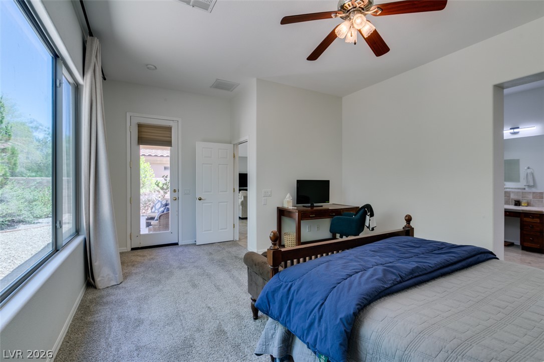 8 Kennesaw Road Henderson, NV 89052 - Photo 31 of 44 A tranquil bedroom retreat features a private patio entrance and plush carpeting underfoot.