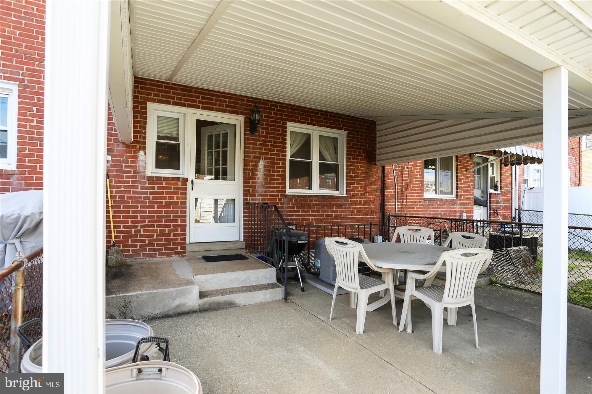 1917 Ormand Road Dundalk, MD 21222 - Photo 4 of 22 a patio with a table and chairs and potted plants