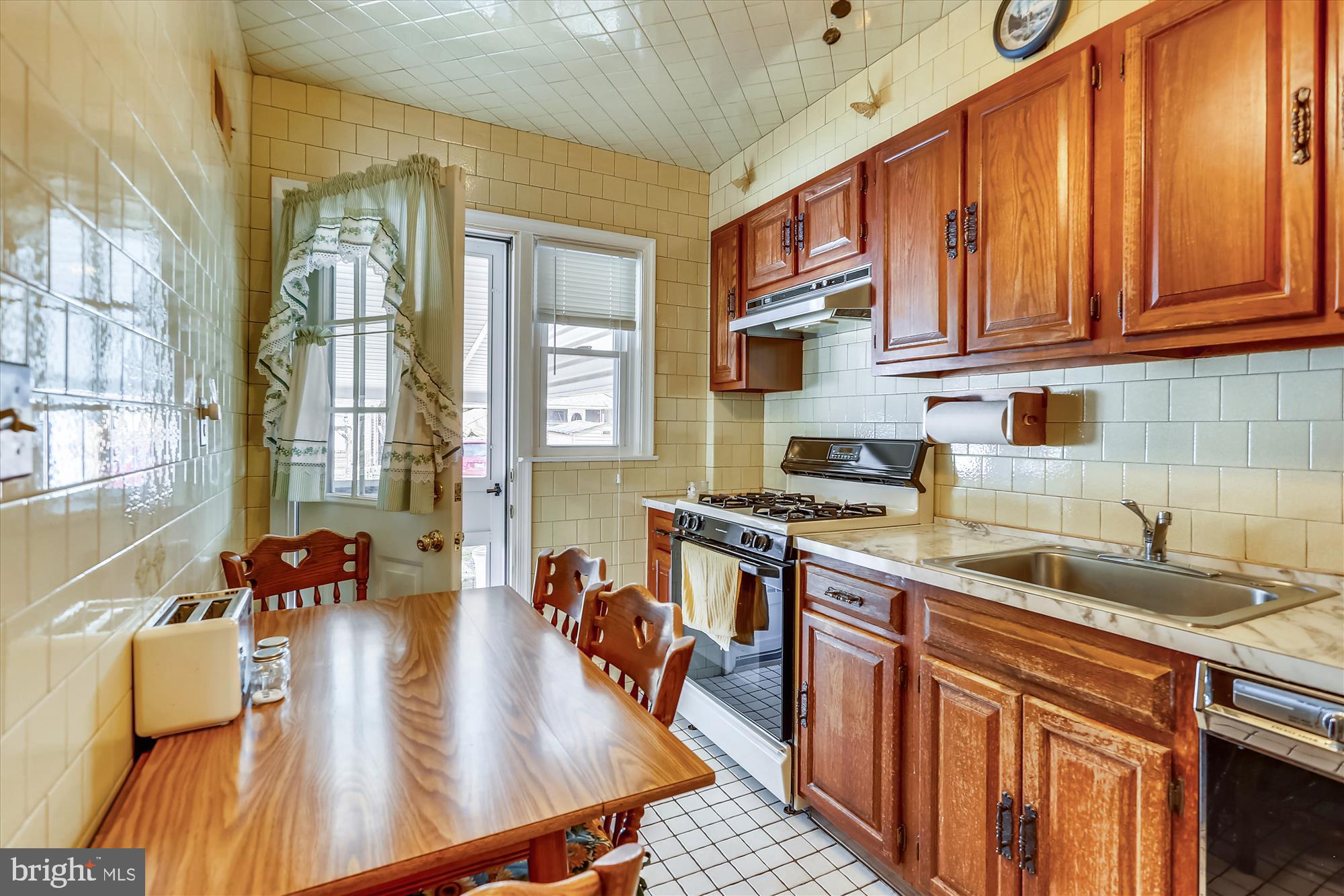1917 Ormand Road Dundalk, MD 21222 - Photo 6 of 22 a kitchen with stainless steel appliances granite countertop a sink a stove and cabinets