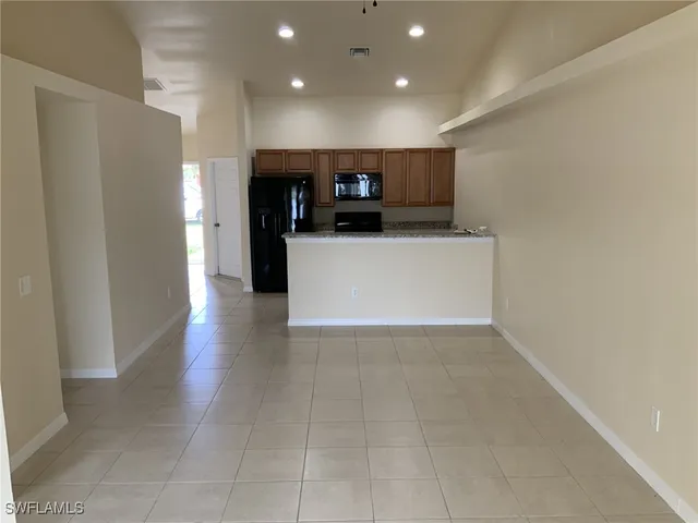 a view of kitchen with cabinets