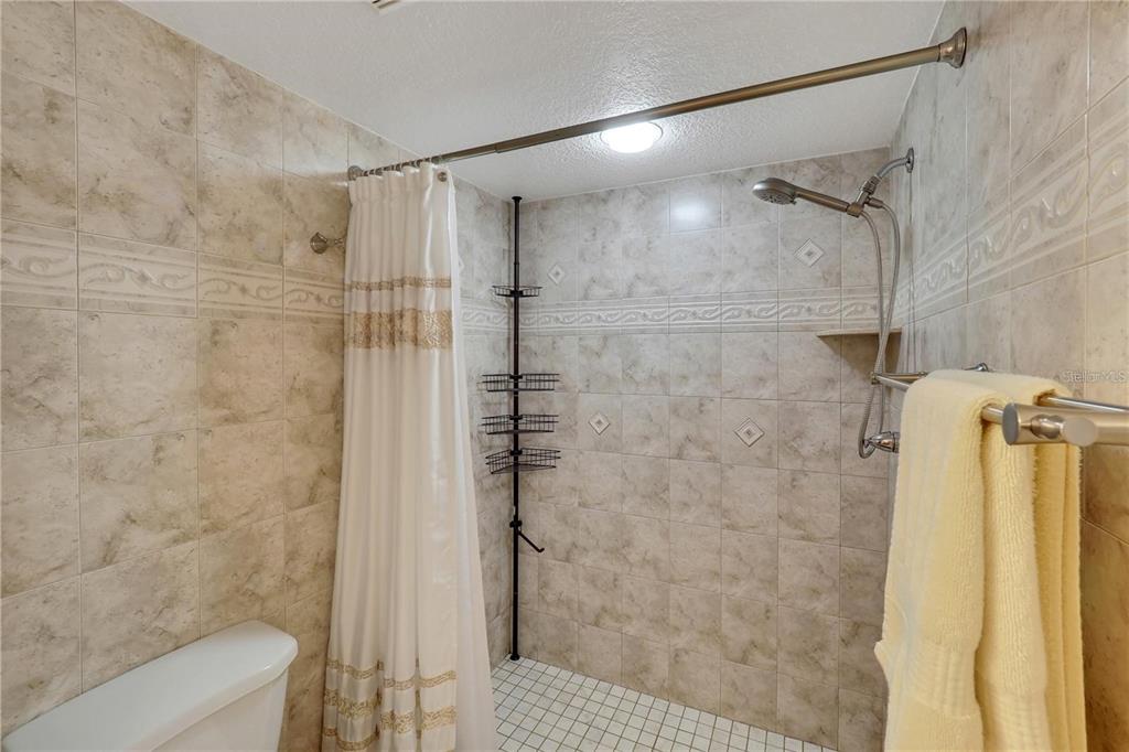 5031 North Beach Road, Unit 116 Englewood, FL 34223 - Photo 20 of 41 a bathroom with a shower