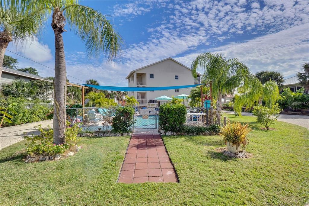 5031 North Beach Road, Unit 116 Englewood, FL 34223 - Photo 25 of 41 a front view of a house with garden