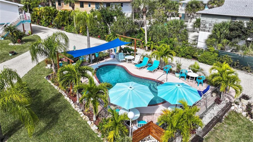5031 North Beach Road, Unit 116 Englewood, FL 34223 - Photo 30 of 41 a view of a swimming pool with a yard