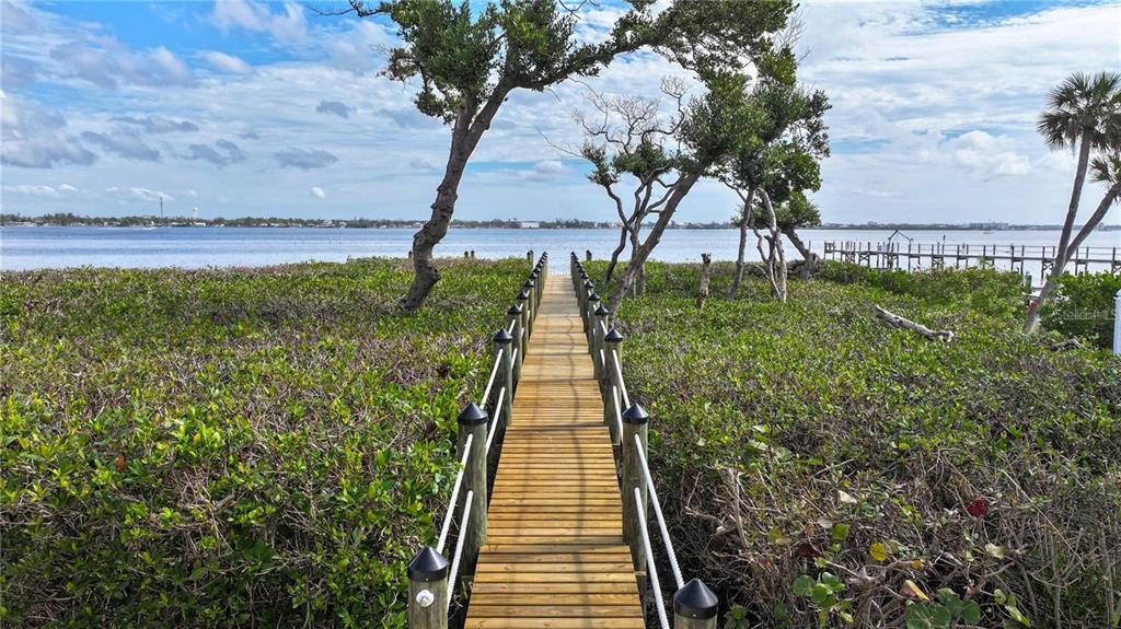 5031 North Beach Road, Unit 116 Englewood, FL 34223 - Photo 31 of 41 a view of a yard with an ocean view