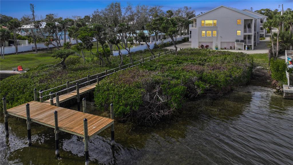 5031 North Beach Road, Unit 116 Englewood, FL 34223 - Photo 41 of 41 a view of a chairs in backyard of the house