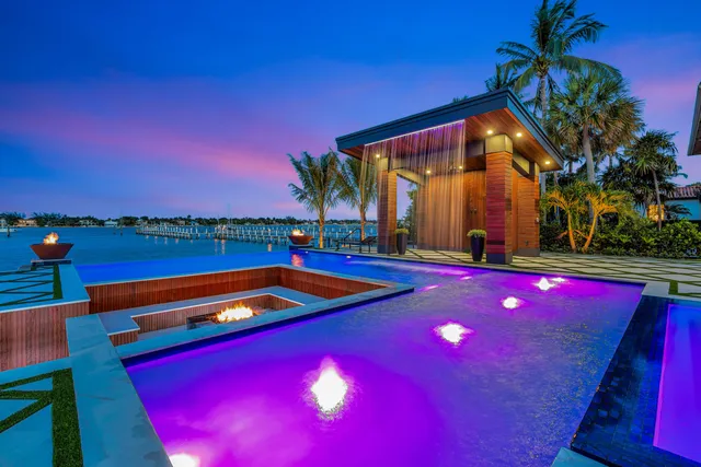 a view of swimming pool with lounge chairs in patio
