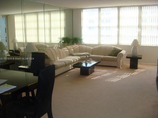 5401 Collins Avenue, Unit 1012 Miami Beach, FL 33140 - Photo 10 of 11 a living room with furniture and a large window