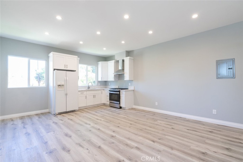 a kitchen with stainless steel appliances a refrigerator sink and cabinets