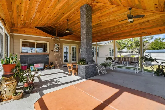 a view of a house with backyard and sitting area