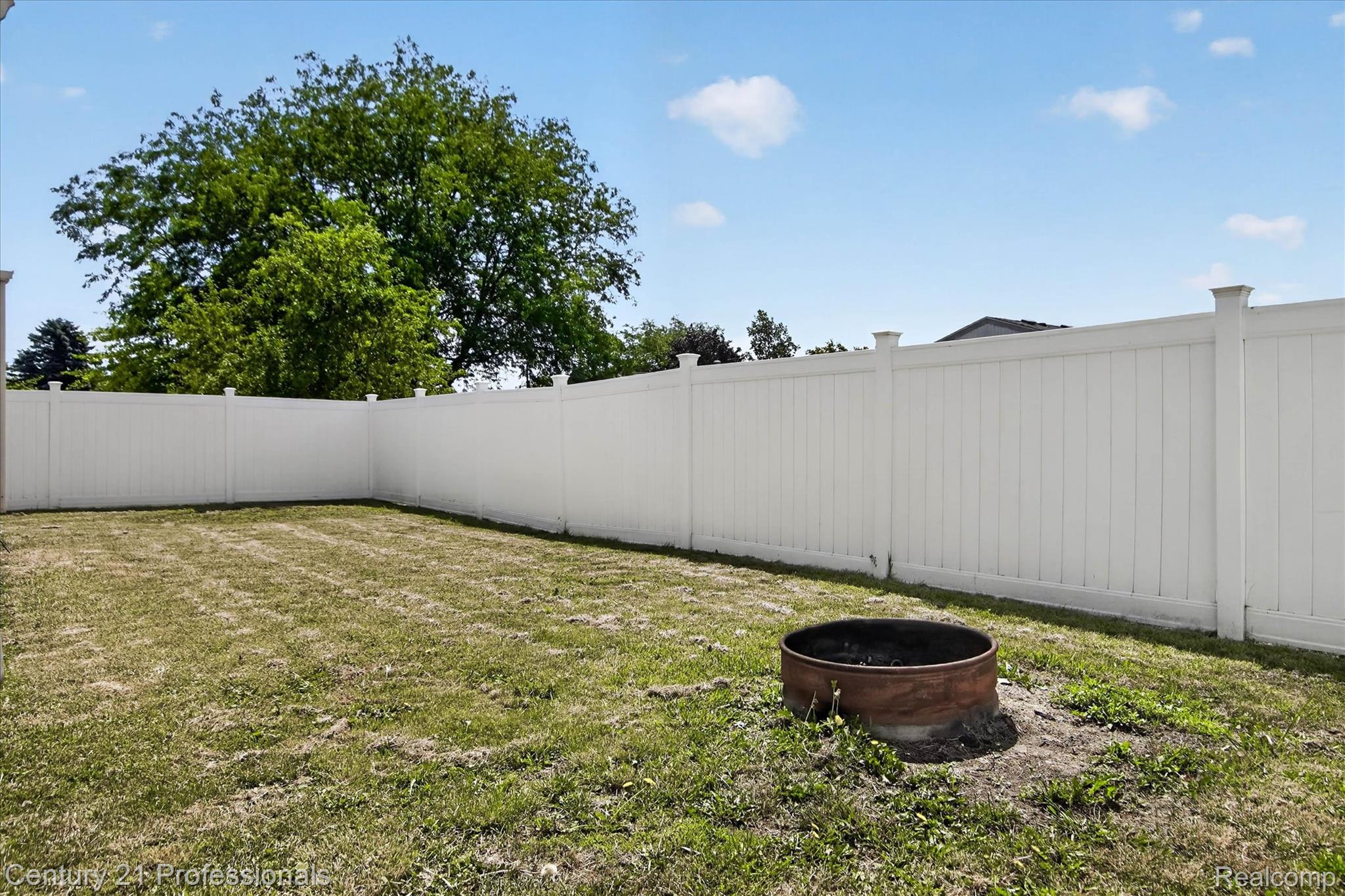 648 Newport Road Carleton, MI 48117 - Photo 35 of 37 Private backyard featuring a full perimeter privacy fence and a built-in fire pit