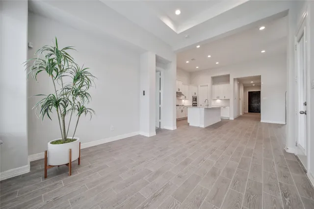 a view of a room with wooden floor and a potted plant