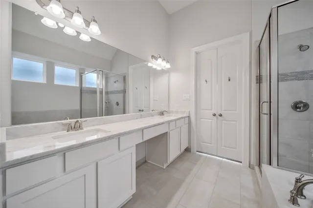 a bathroom with a double vanity sink and a mirror