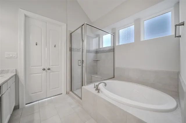 a bathroom with a bathtub and a shower
