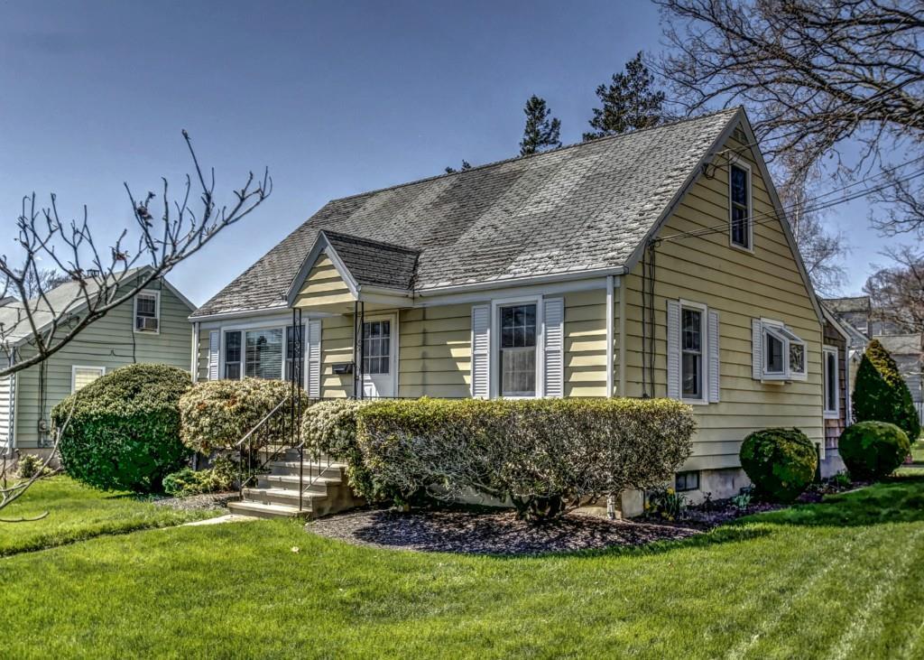 a front view of a house with a garden