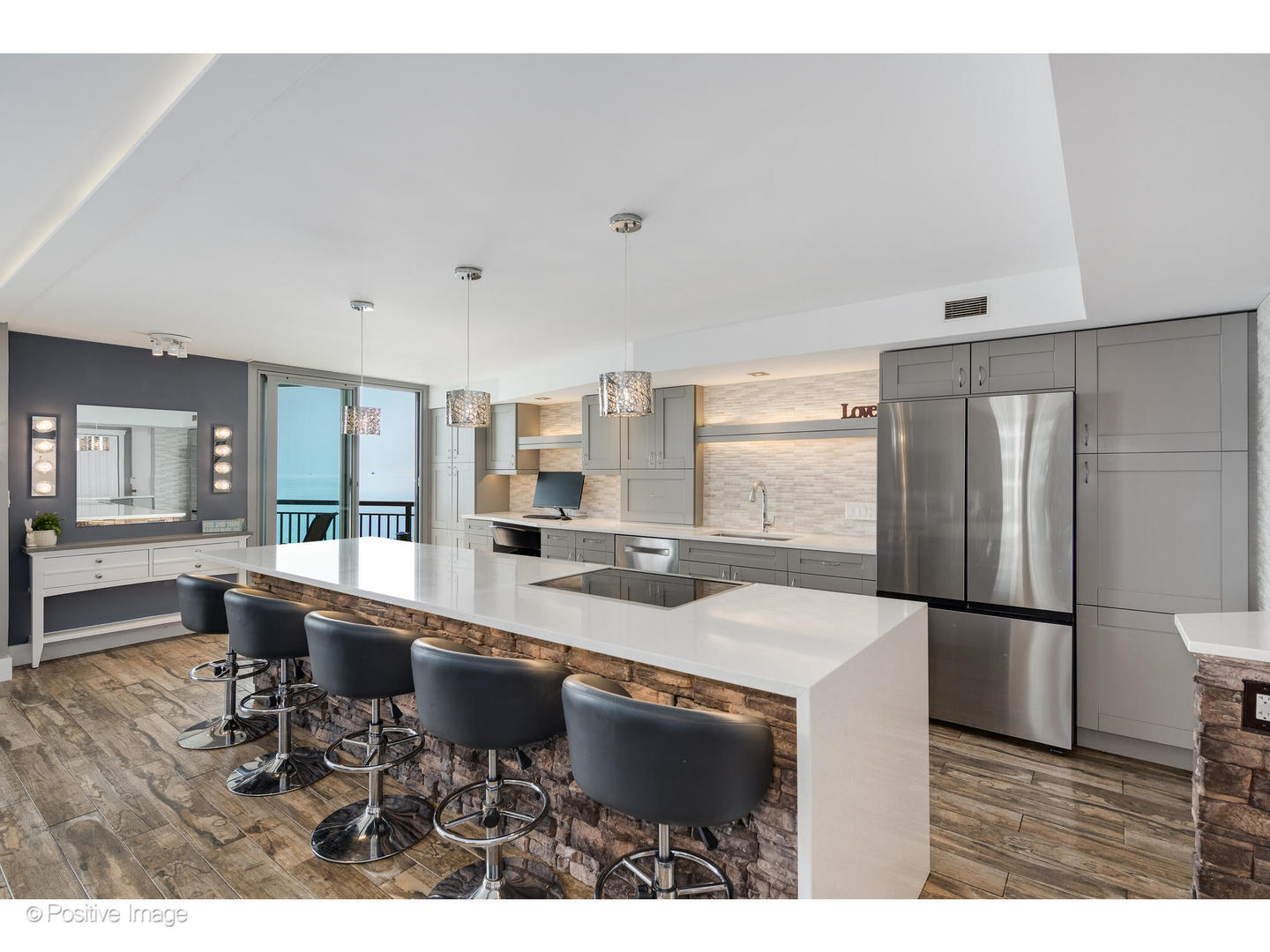 6007 North Sheridan Road, Unit 8B Chicago, IL 60660 - Photo 8 of 23 a open kitchen with stainless steel appliances granite countertop a sink refrigerator and cabinets
