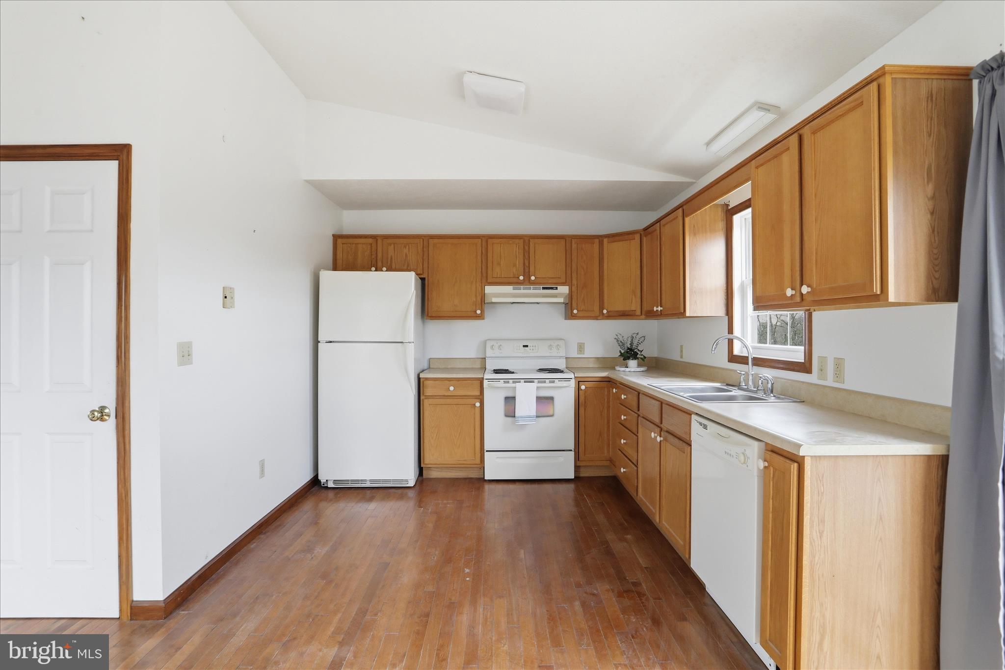 316 East Ridge Loop Road Romney, WV 26757 - Photo 12 of 33 a kitchen with a white cabinets and wooden floor