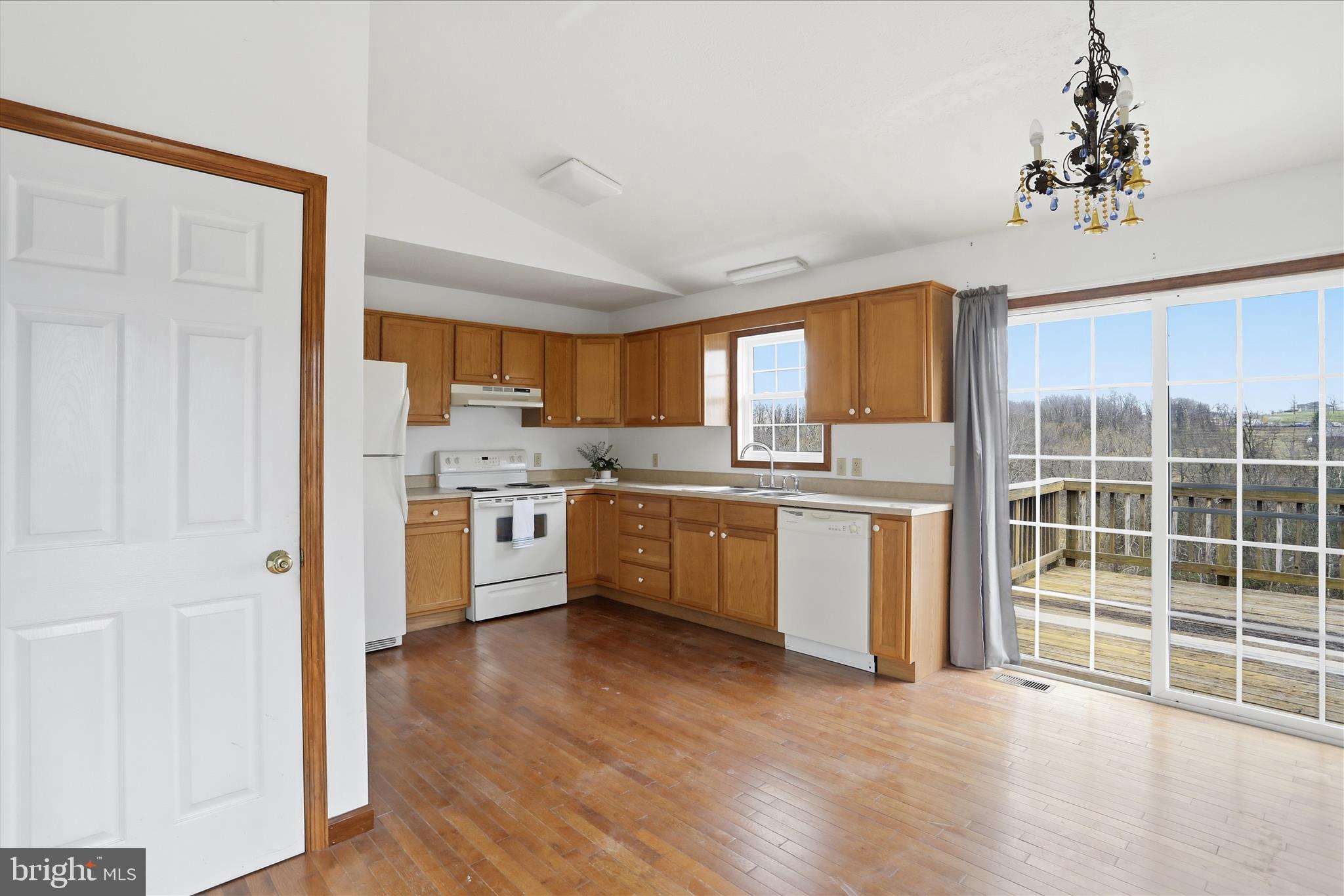 316 East Ridge Loop Road Romney, WV 26757 - Photo 9 of 33 a kitchen with wooden floors and white stainless steel appliances
