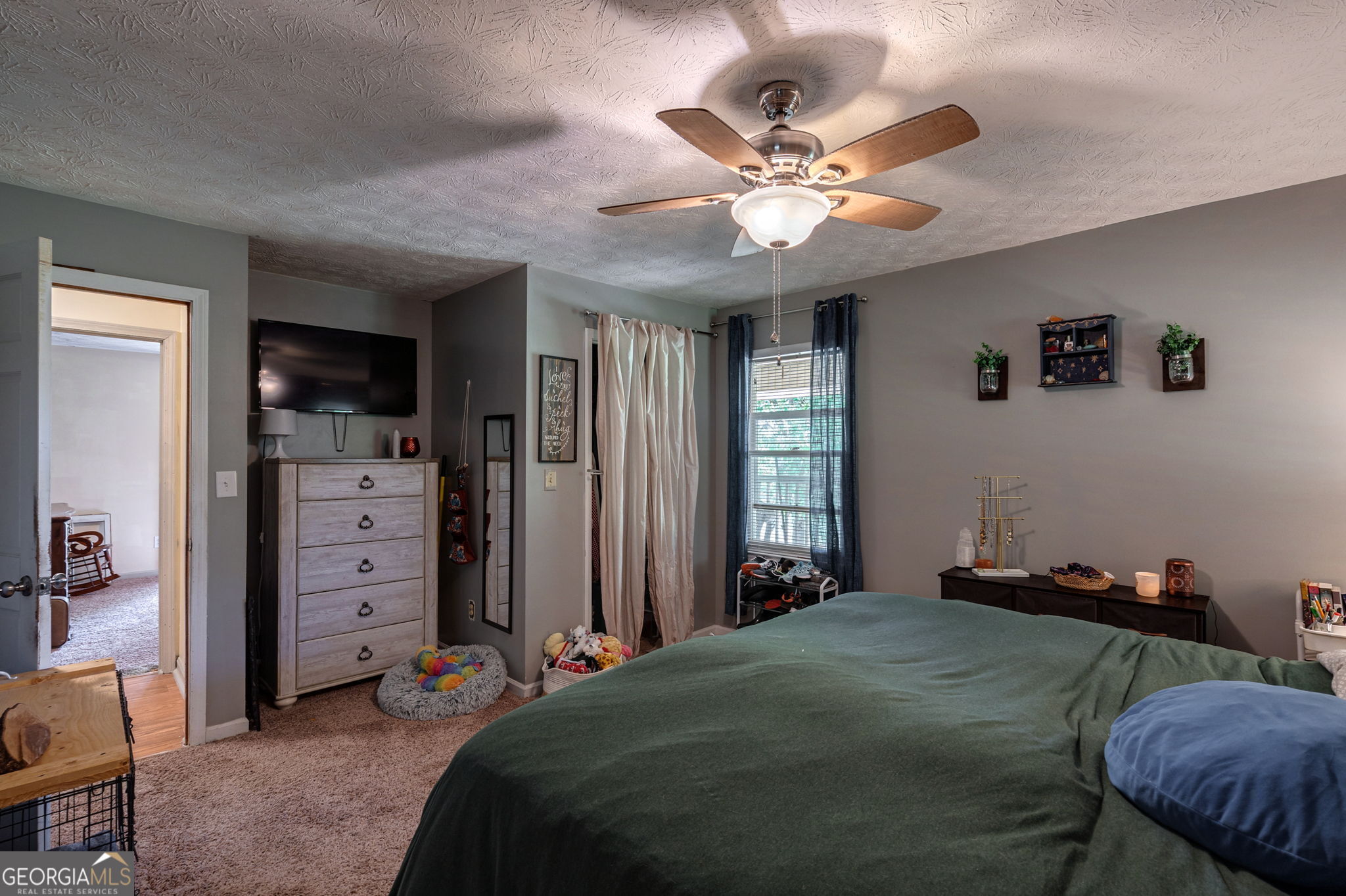 1281 Apalachee River Road Madison, GA 30650 - Photo 43 of 98 a bedroom with a bed and a chandelier