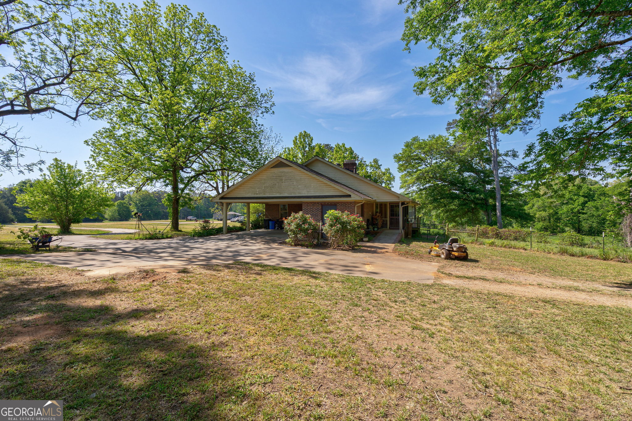 1281 Apalachee River Road Madison, GA 30650 - Photo 47 of 98 a backyard of a house with table and chairs under an umbrella
