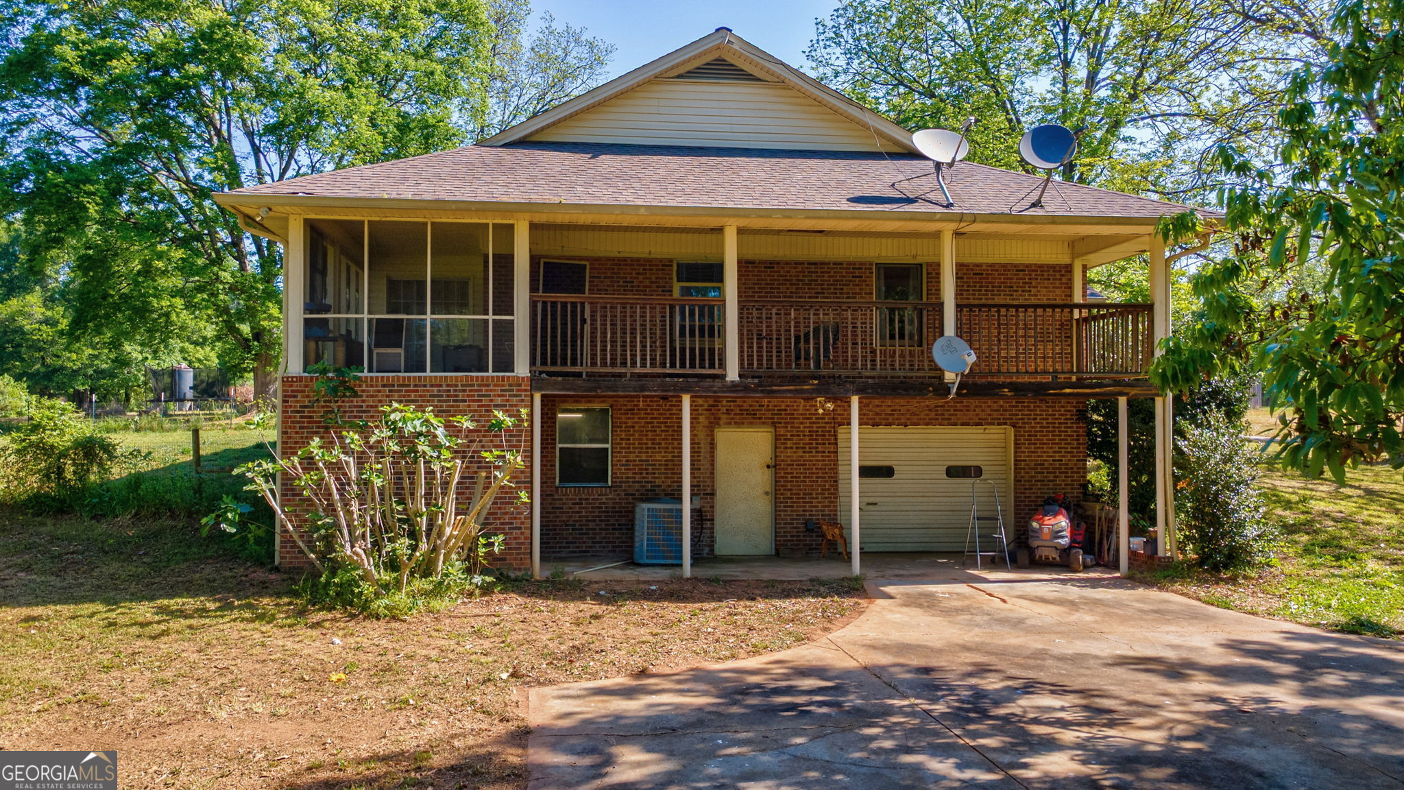 1281 Apalachee River Road Madison, GA 30650 - Photo 76 of 98 a front view of a house with a yard and garage