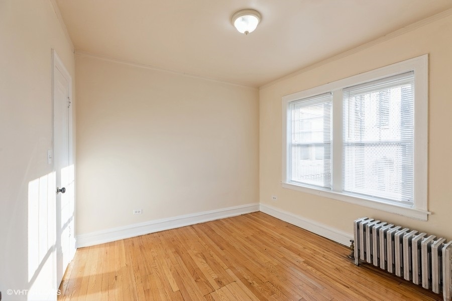 10981 South Church Street, Unit 3B Chicago, IL 60643 - Photo 6 of 8 an empty room with wooden floor and windows