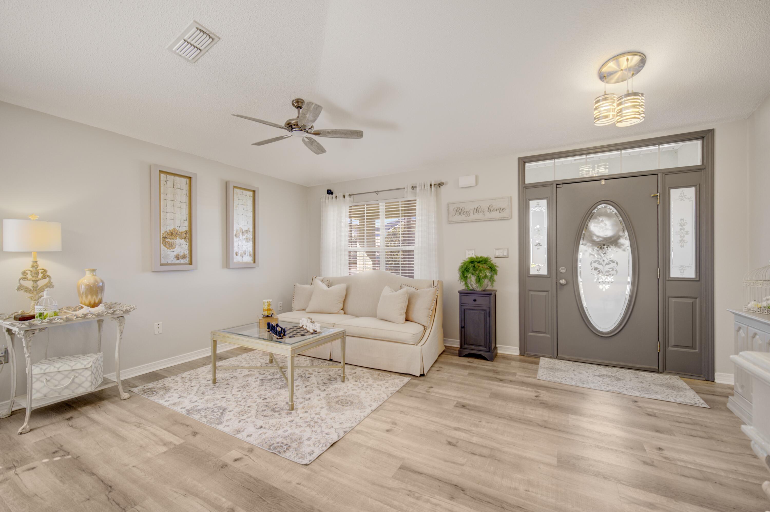 35 Red Bay Court Santa Rosa Beach, FL 32459 - Photo 16 of 73 a living room with furniture a clock and a window