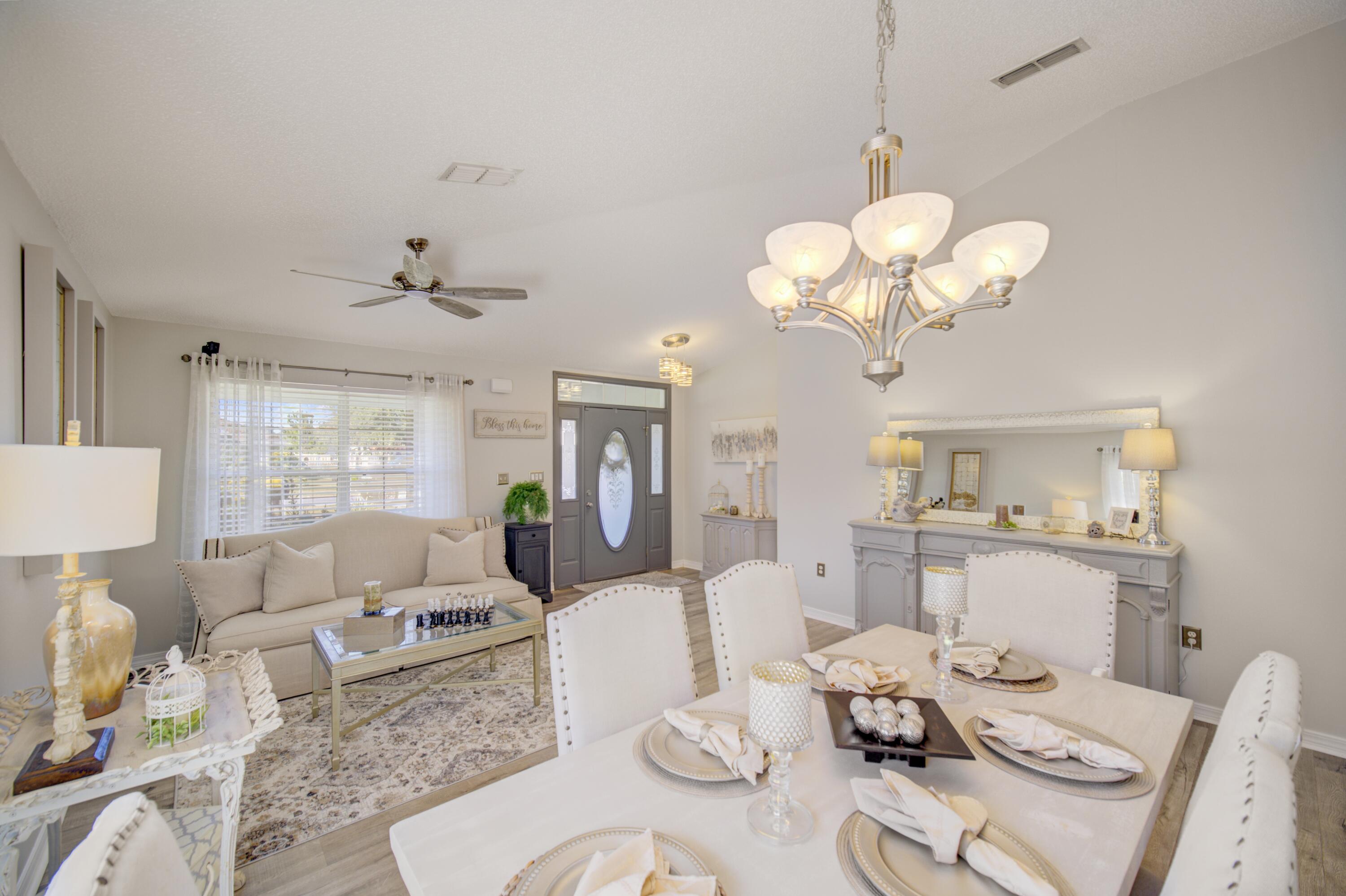 35 Red Bay Court Santa Rosa Beach, FL 32459 - Photo 18 of 73 a living room with furniture chandelier and view of kitchen