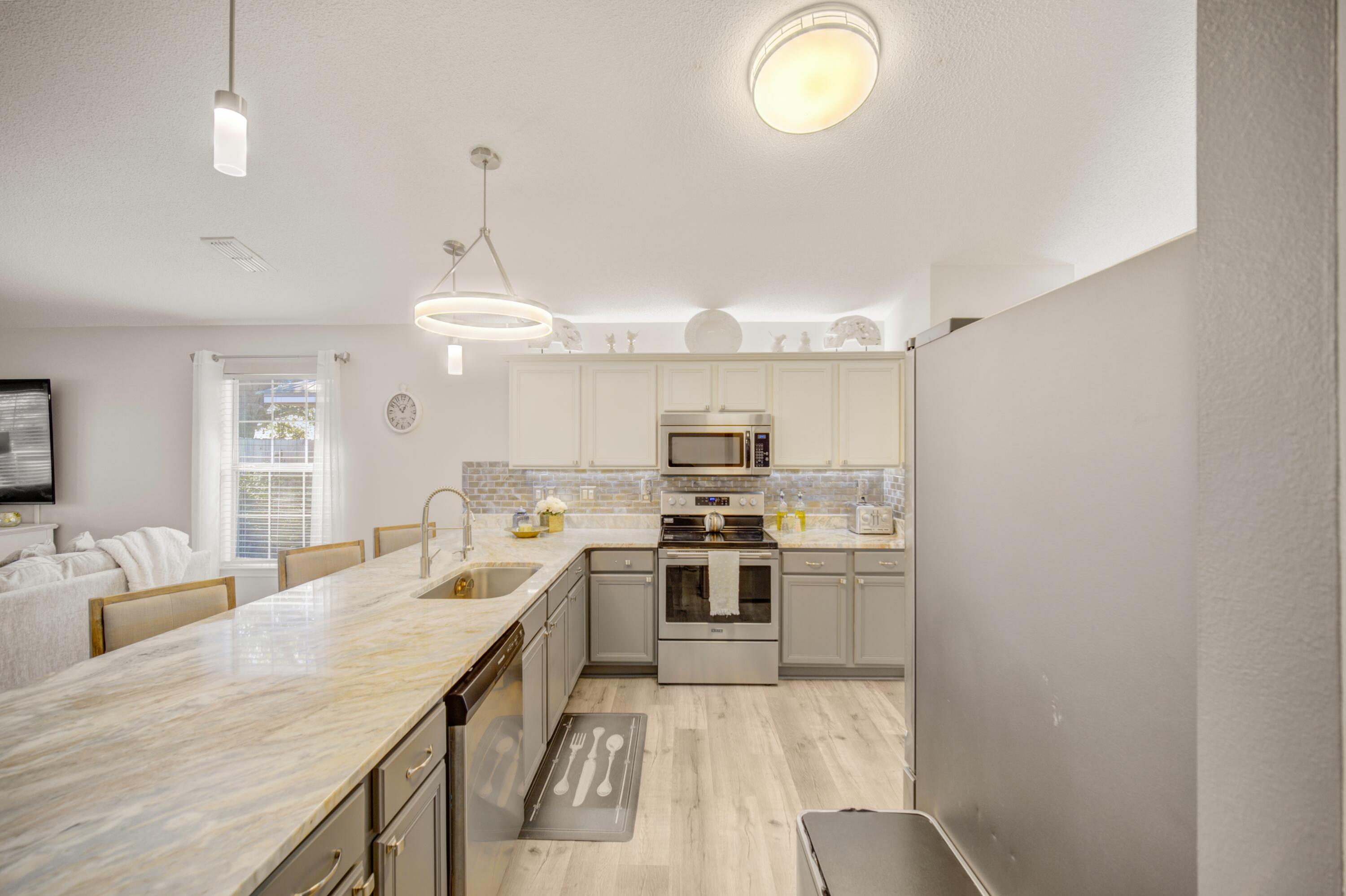 35 Red Bay Court Santa Rosa Beach, FL 32459 - Photo 25 of 73 a large kitchen with cabinets and stainless steel appliances