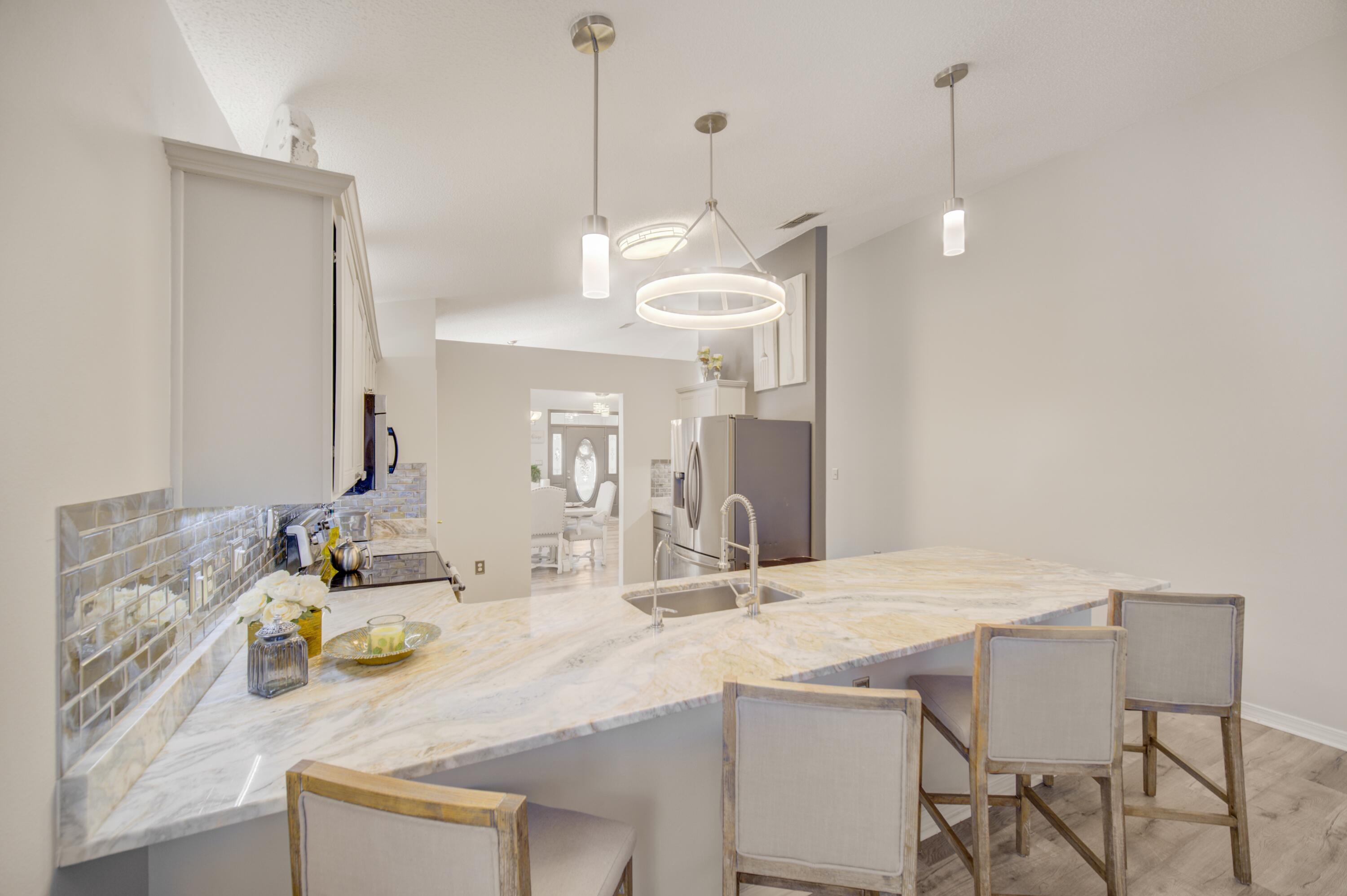 35 Red Bay Court Santa Rosa Beach, FL 32459 - Photo 29 of 73 a kitchen with a dining table and chairs
