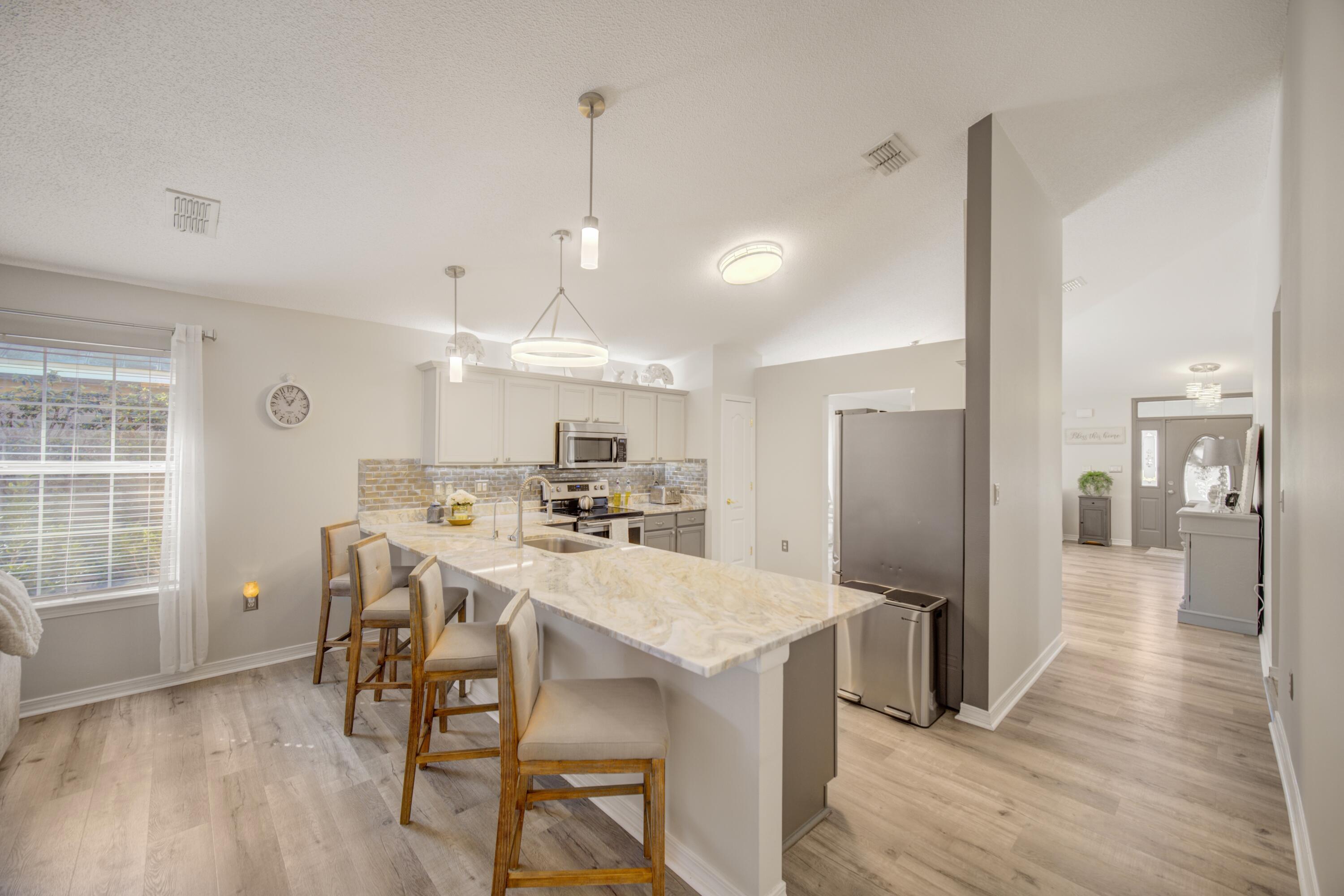 35 Red Bay Court Santa Rosa Beach, FL 32459 - Photo 30 of 73 a large kitchen with a table and chairs