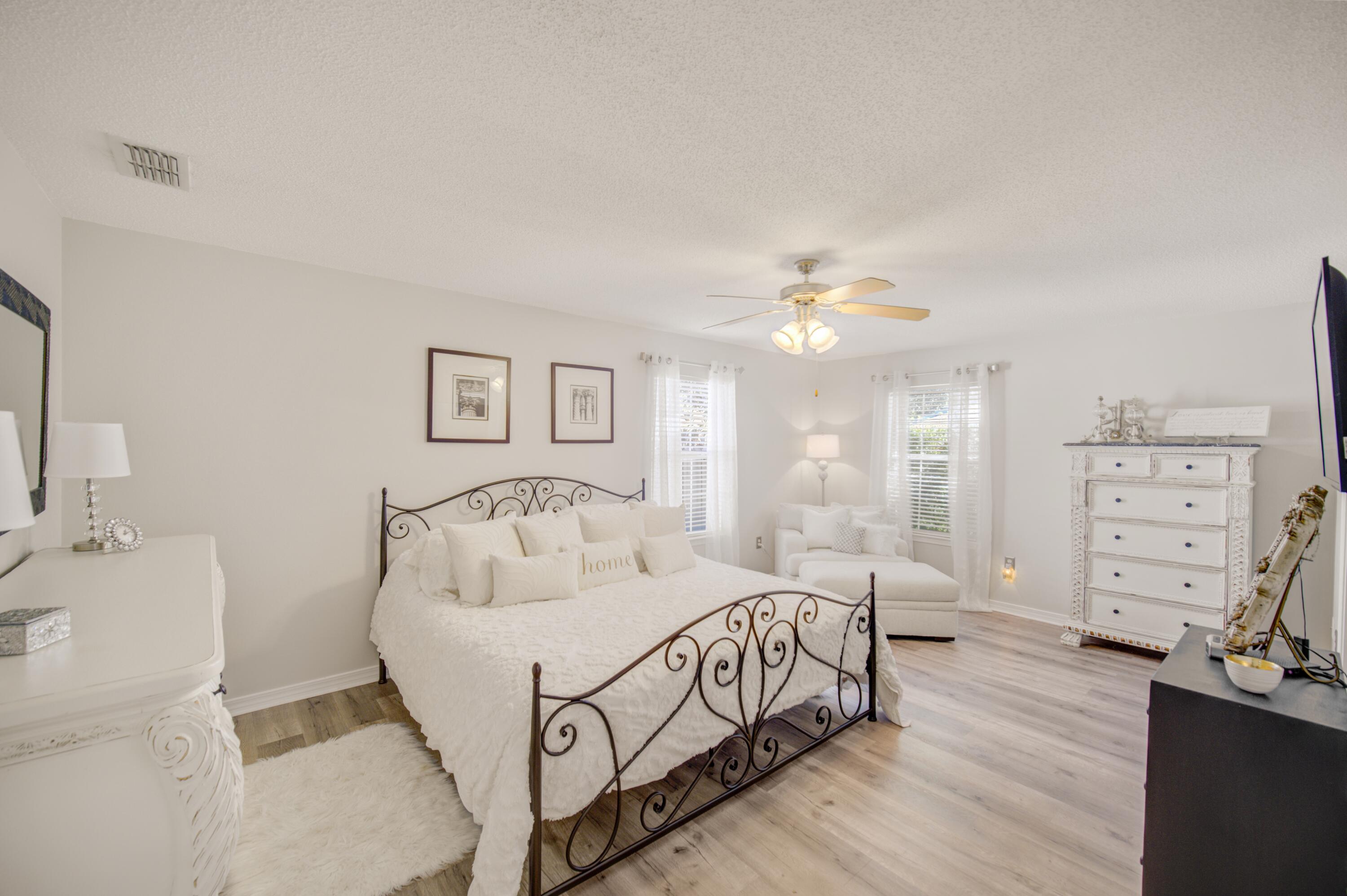 35 Red Bay Court Santa Rosa Beach, FL 32459 - Photo 37 of 73 a bedroom with a large bed and a chandelier