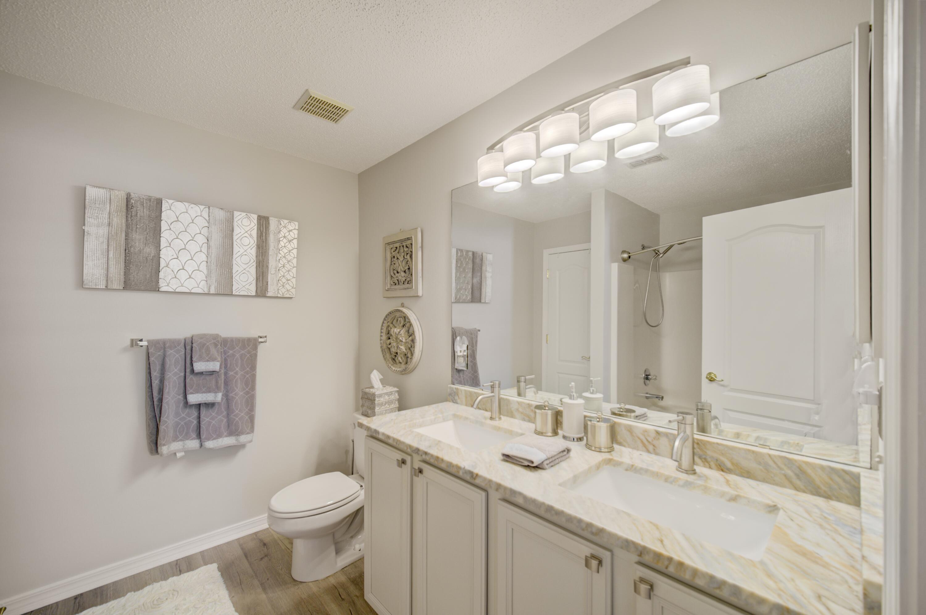 35 Red Bay Court Santa Rosa Beach, FL 32459 - Photo 40 of 73 a bathroom with a toilet sink double vanity and mirror