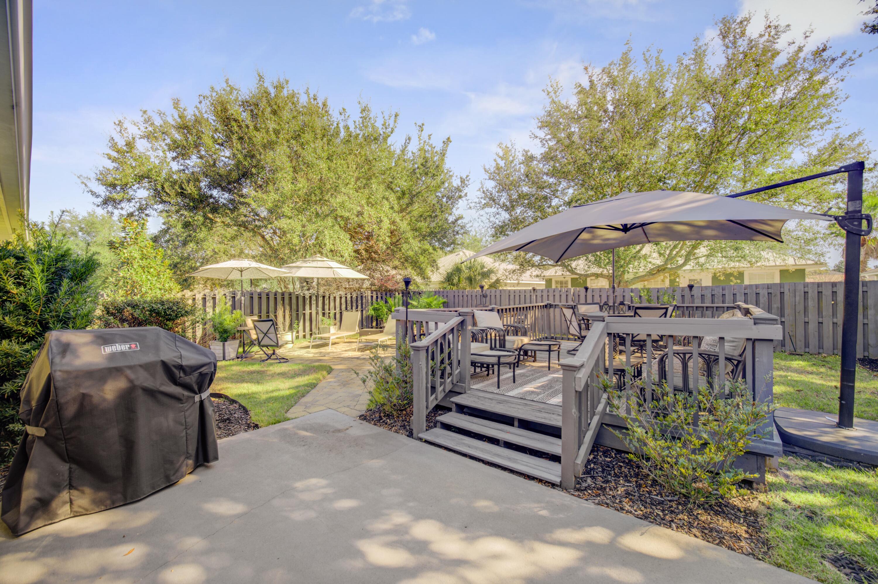 35 Red Bay Court Santa Rosa Beach, FL 32459 - Photo 53 of 73 a view of a patio with a table and chairs under an umbrella