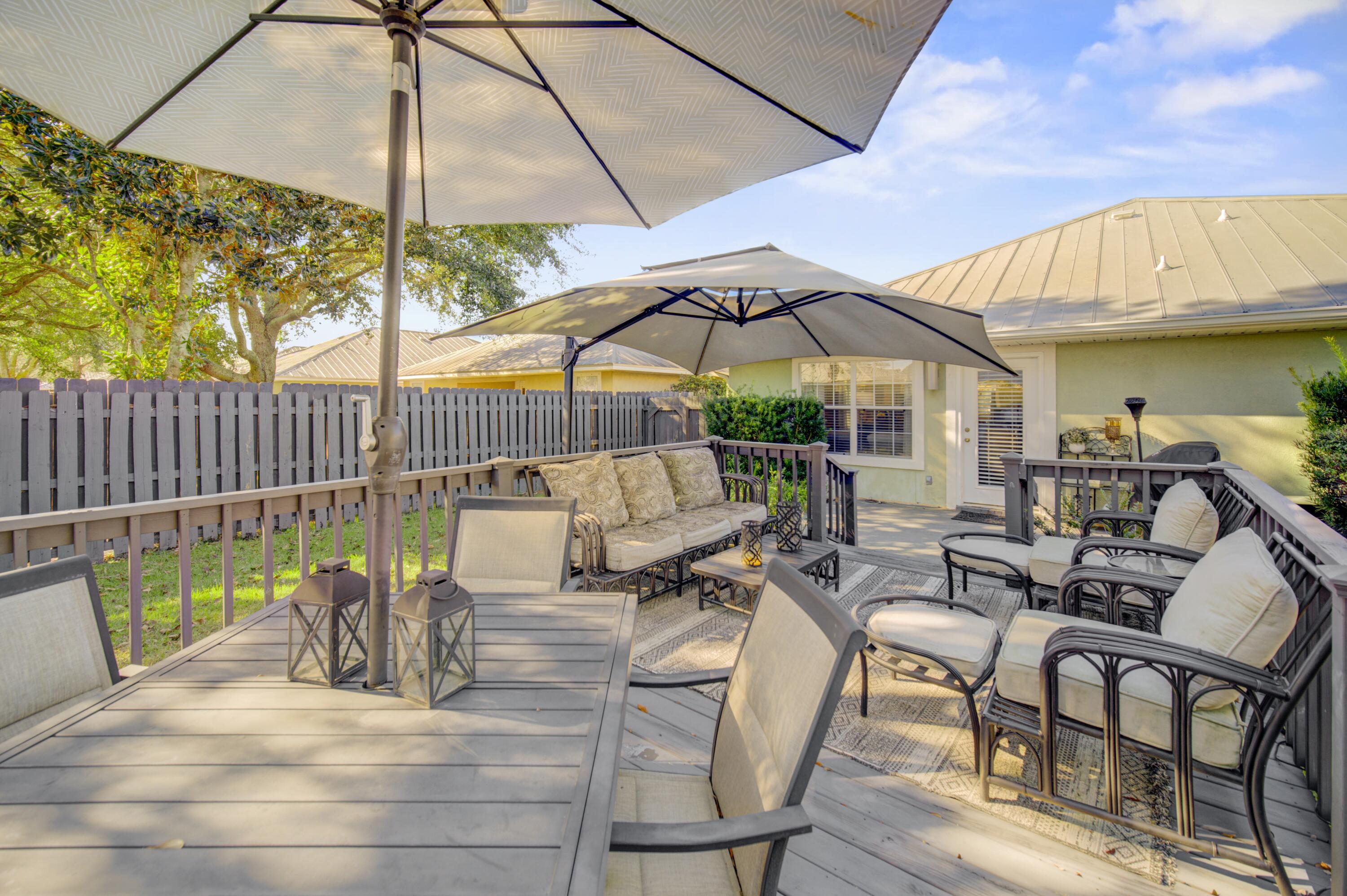 35 Red Bay Court Santa Rosa Beach, FL 32459 - Photo 54 of 73 a view of a patio with table and chairs under an umbrella