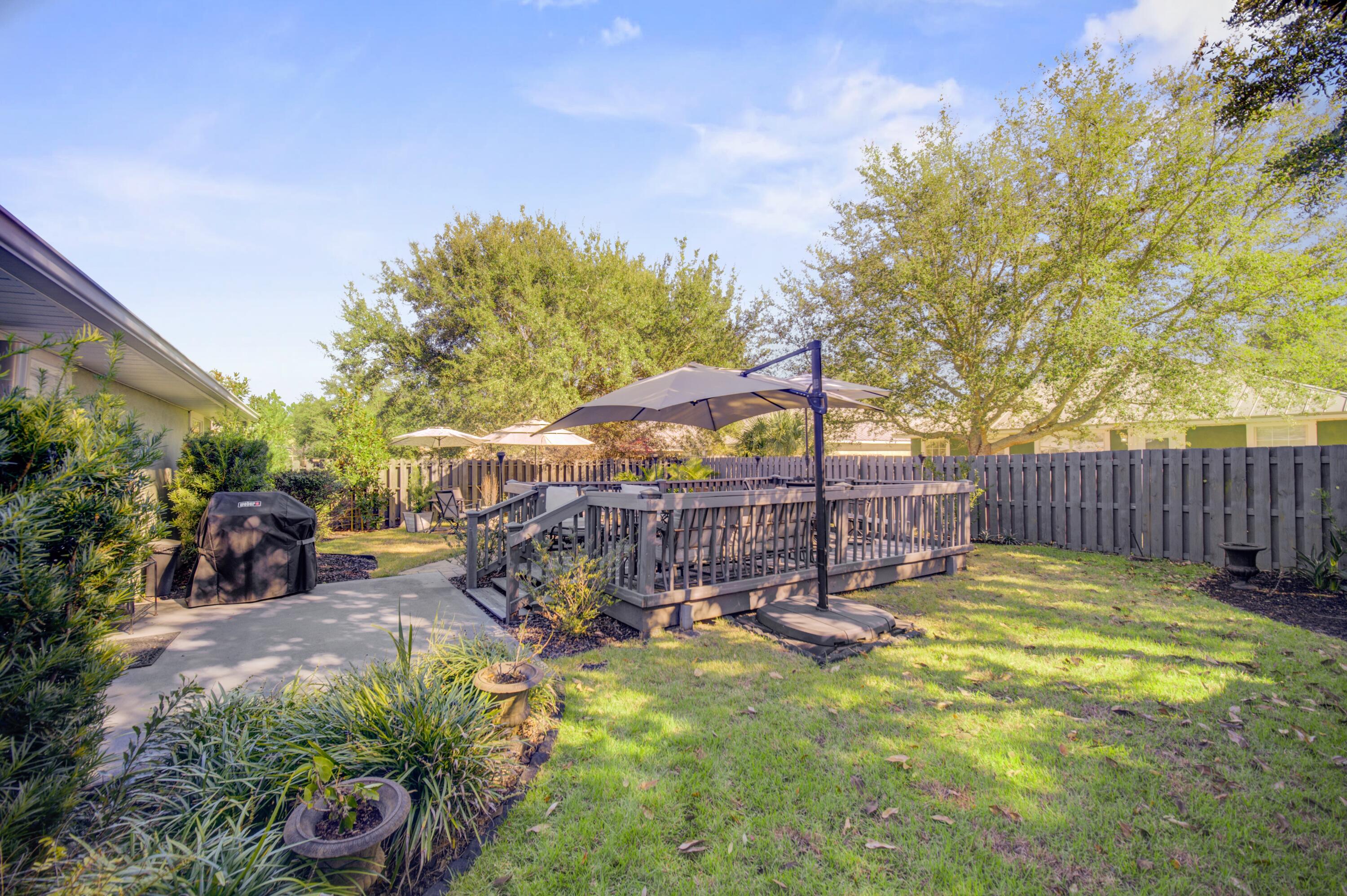 35 Red Bay Court Santa Rosa Beach, FL 32459 - Photo 56 of 73 a view of a chairs and tables in the back yard of the house