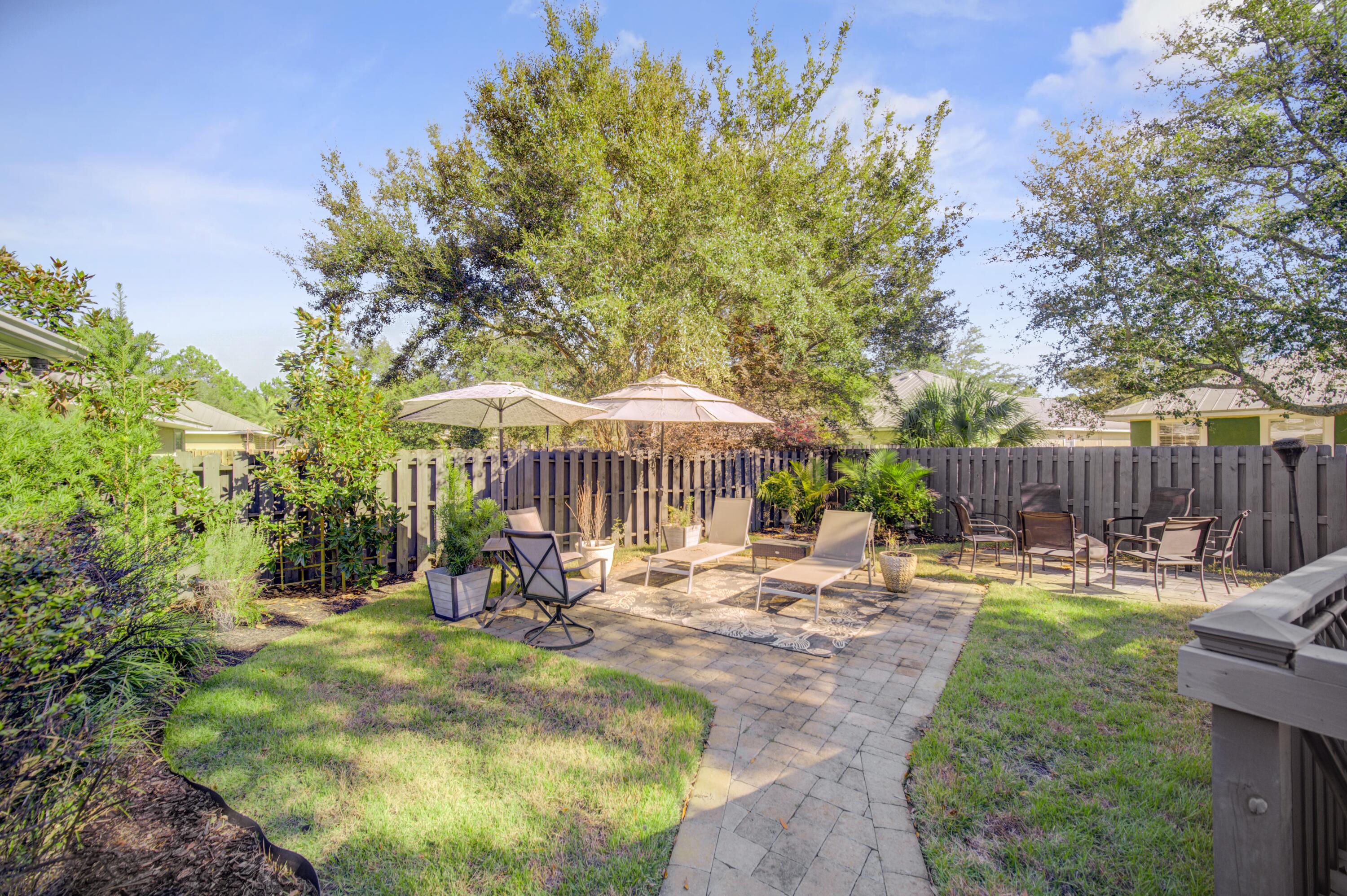 35 Red Bay Court Santa Rosa Beach, FL 32459 - Photo 57 of 73 a backyard of a house with table and chairs