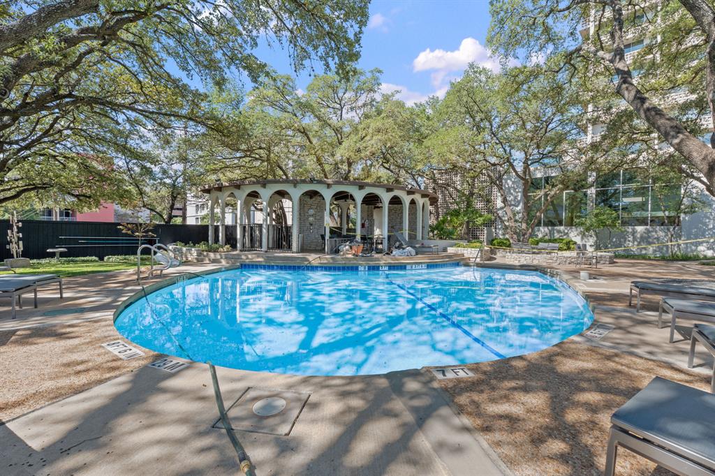 1801 Lavaca Street, Unit 12K Austin, TX 78701 - Photo 24 of 27 Community pool with a patio and view of wooded area