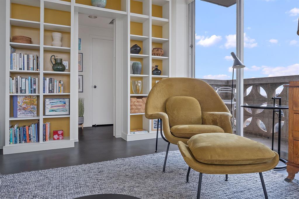 1801 Lavaca Street, Unit 12K Austin, TX 78701 - Photo 5 of 27 Sitting room with built in shelves and dark wood finished floors