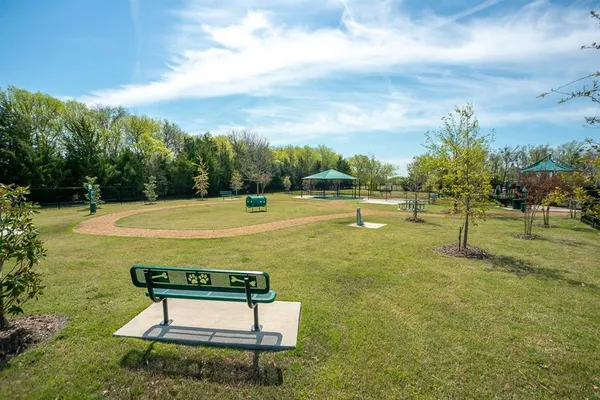 a kitchen with stainless steel appliances a table chairs refrigerator and cabinets