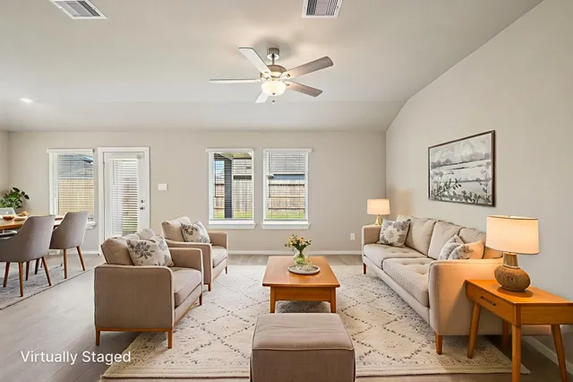 a living room with furniture and a large window