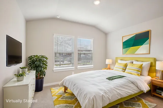 a bedroom with a bed and flat screen tv